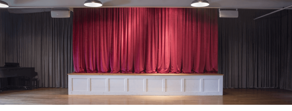 ASK's theater space, with curtains drawn over the stage